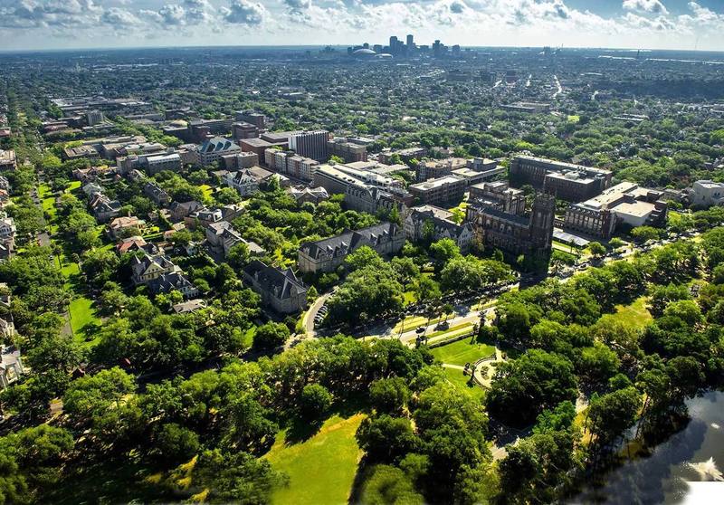 Aerial view of Tulane's Uptown campus and Audubon Park, with downtown New Orleans on the horizon